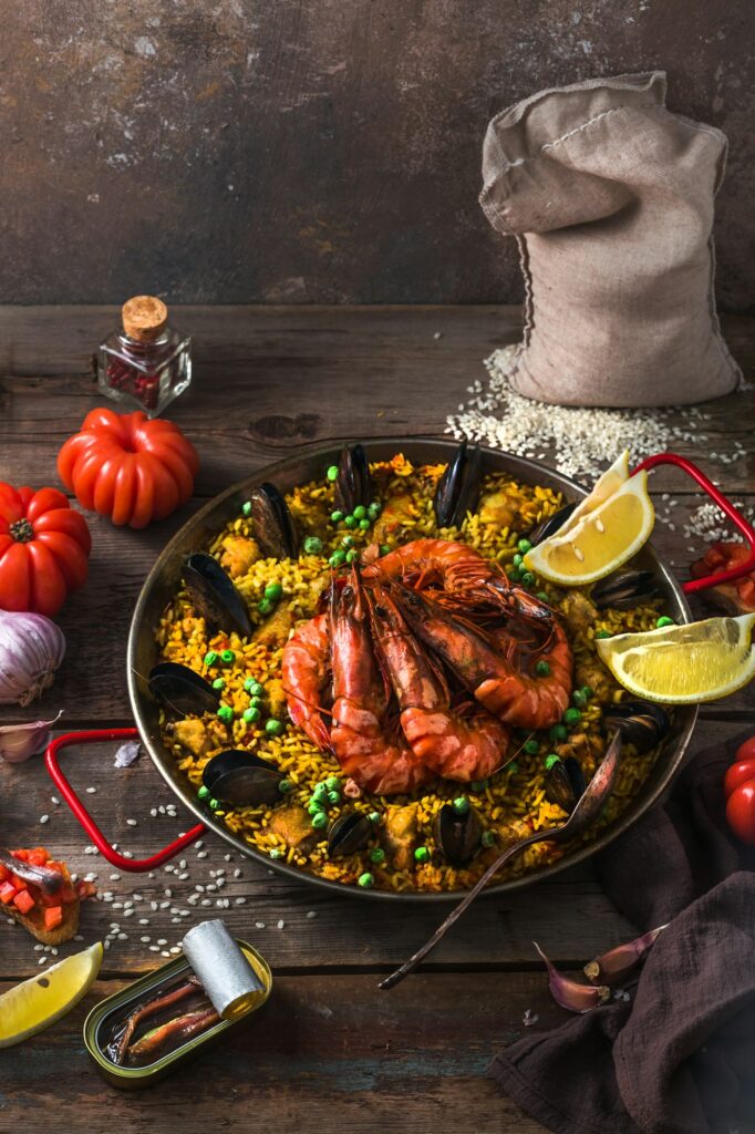 Traditional paella with shrimps, calamari and mussels in paellara pan