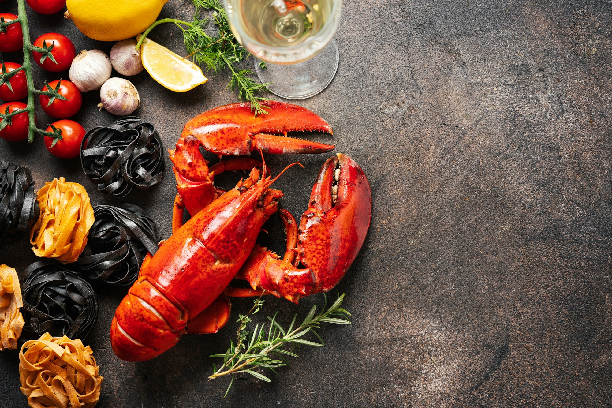 Food background with pasta, cooked lobster and wine